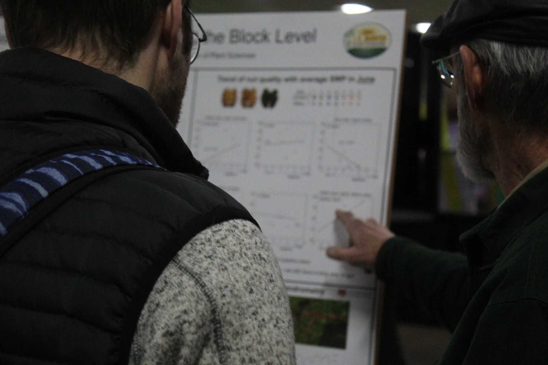 Attendees examine walnut research findings at a poster during the 2026 California Walnut Conference.