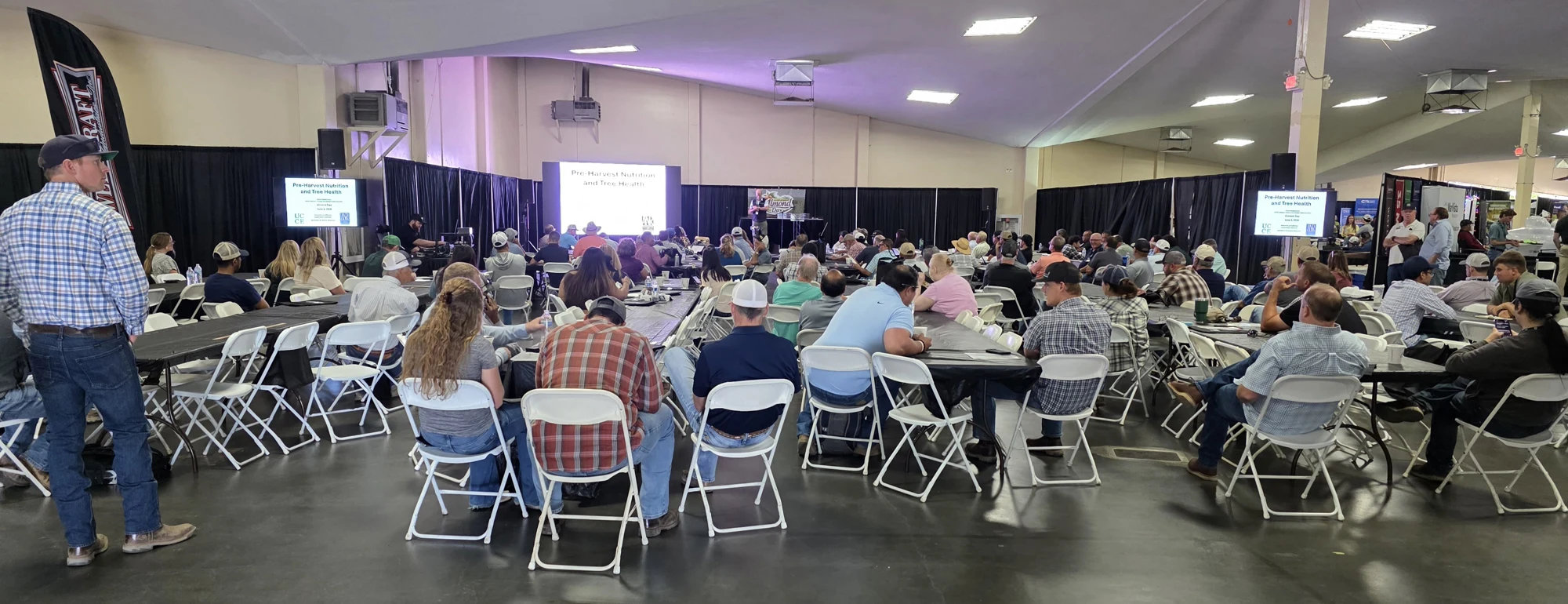 The Almond Day audience seated across the conference hall for a presentation in 2026.