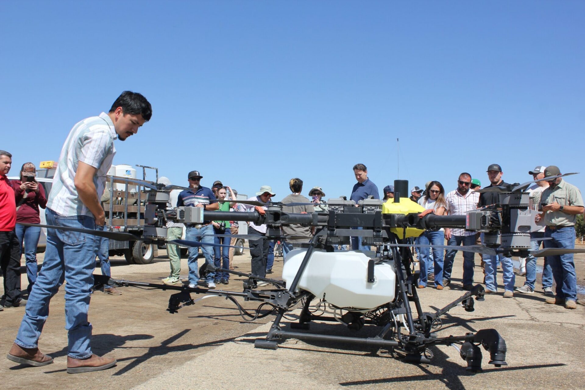 Drone workshop participants take a close-up look at an Ag-Bee drone.